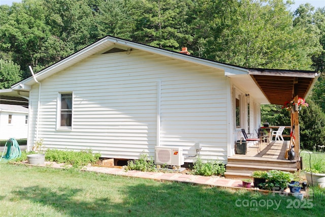 view of home's exterior with ac unit, a lawn, and a wooden deck