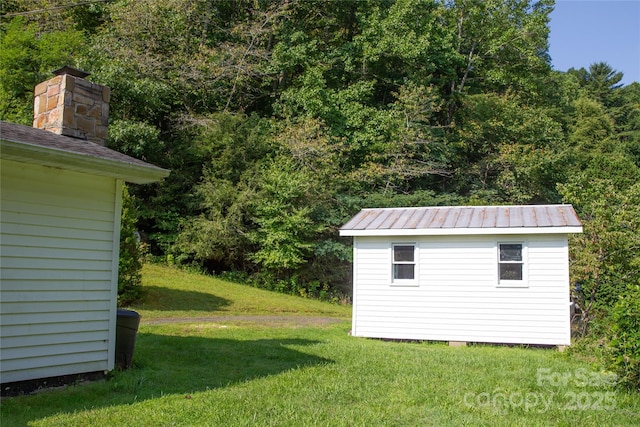 view of yard with an outbuilding and a storage shed