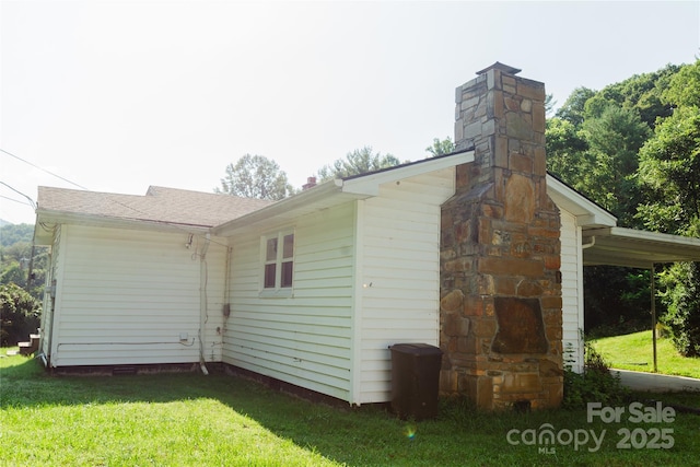 view of property exterior featuring a chimney and a lawn