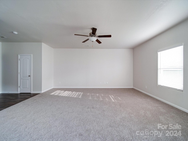 carpeted spare room with ceiling fan