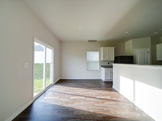 unfurnished living room with wood-type flooring