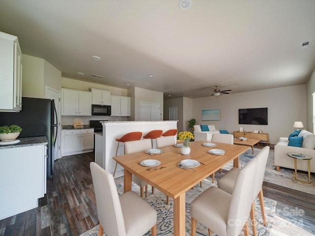 dining area with ceiling fan and dark hardwood / wood-style floors