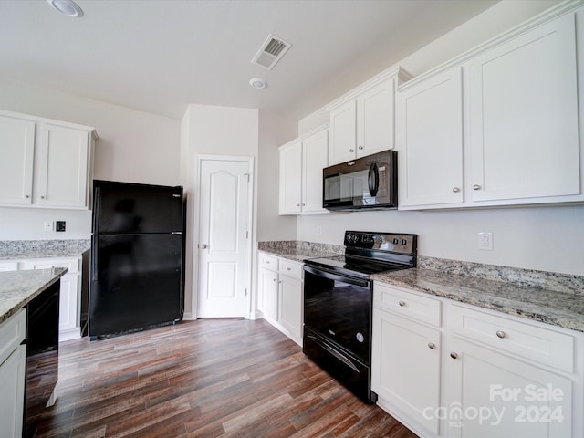 kitchen with black appliances, white cabinets, light stone counters, and hardwood / wood-style floors