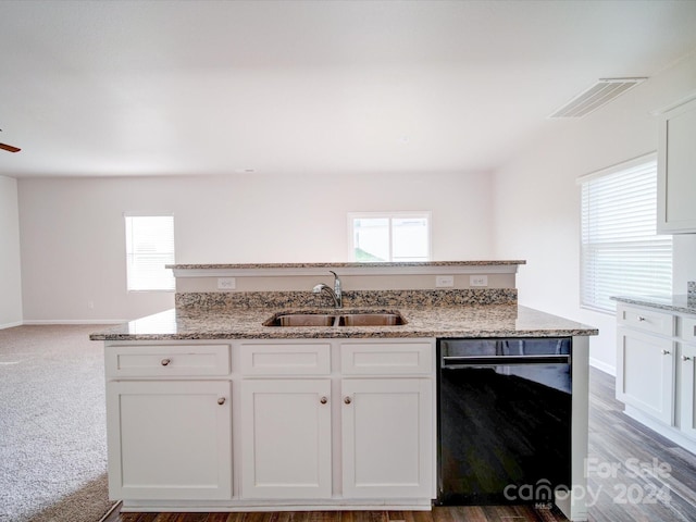 kitchen featuring black dishwasher, white cabinets, light stone countertops, sink, and carpet floors