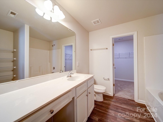 full bathroom featuring  shower combination, hardwood / wood-style flooring, vanity, and toilet