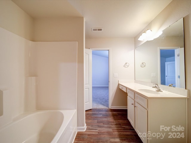 bathroom with vanity and hardwood / wood-style floors