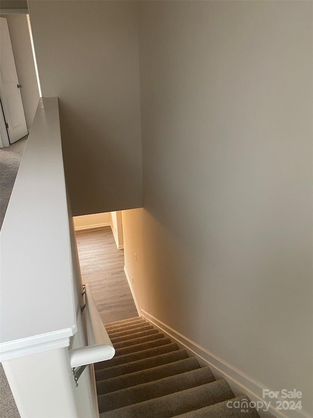 stairway featuring hardwood / wood-style flooring