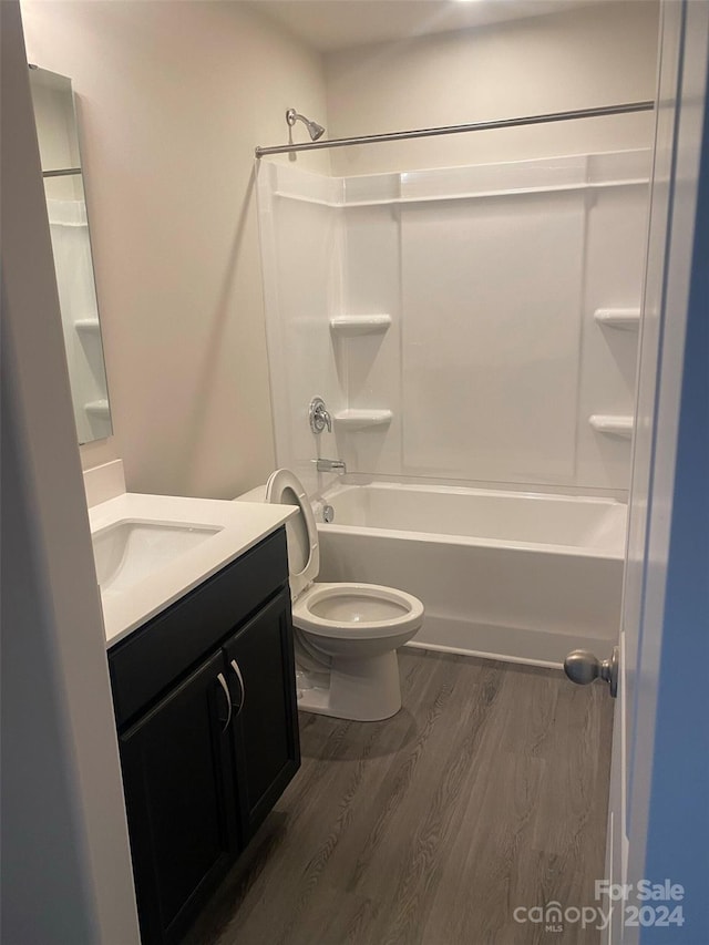 full bathroom featuring toilet, vanity, shower / bathtub combination, and hardwood / wood-style flooring