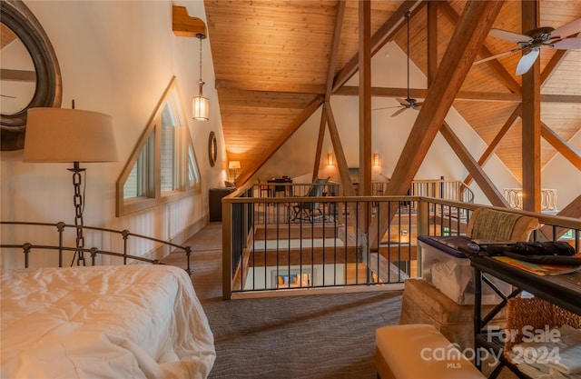 bedroom with vaulted ceiling with beams and wood ceiling