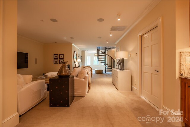 carpeted living room with crown molding