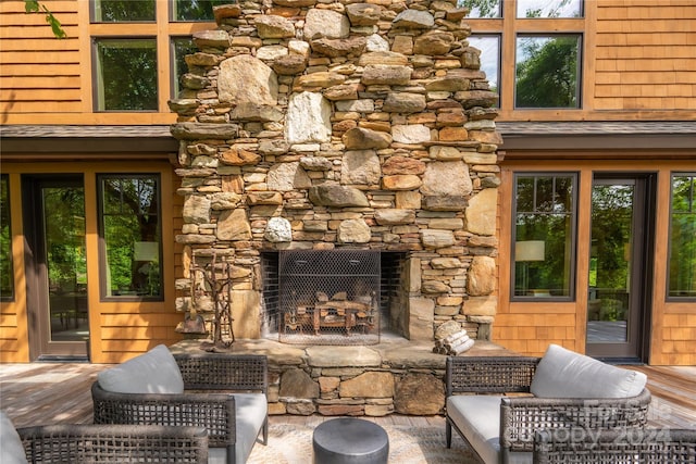 view of patio / terrace featuring a stone fireplace