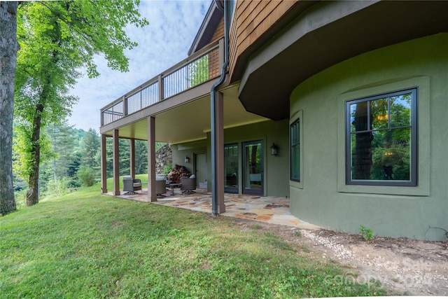 exterior space with a patio area and a lawn