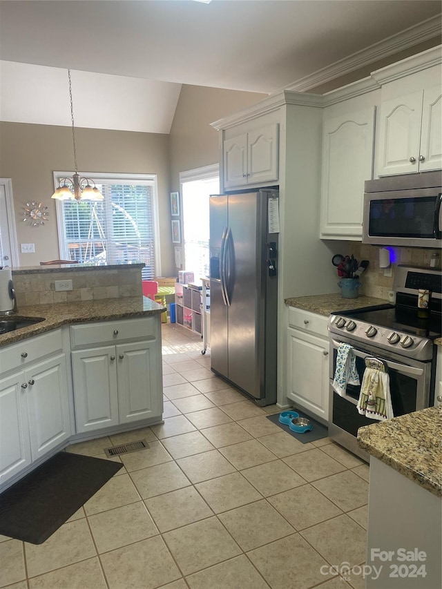 kitchen with appliances with stainless steel finishes, backsplash, stone countertops, white cabinetry, and a notable chandelier