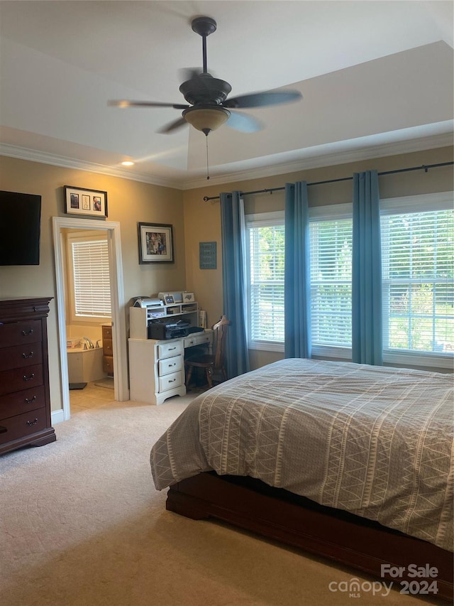 bedroom featuring ensuite bath, ceiling fan, ornamental molding, and light colored carpet