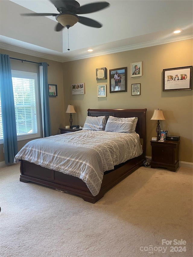 carpeted bedroom with crown molding and ceiling fan