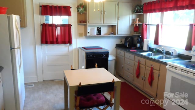 kitchen with sink, a center island, light colored carpet, and white appliances