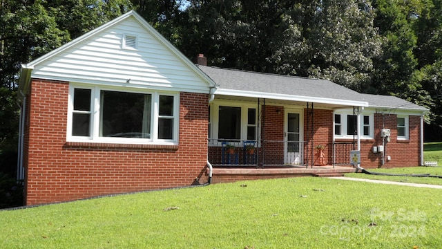 view of front of home with covered porch and a front yard