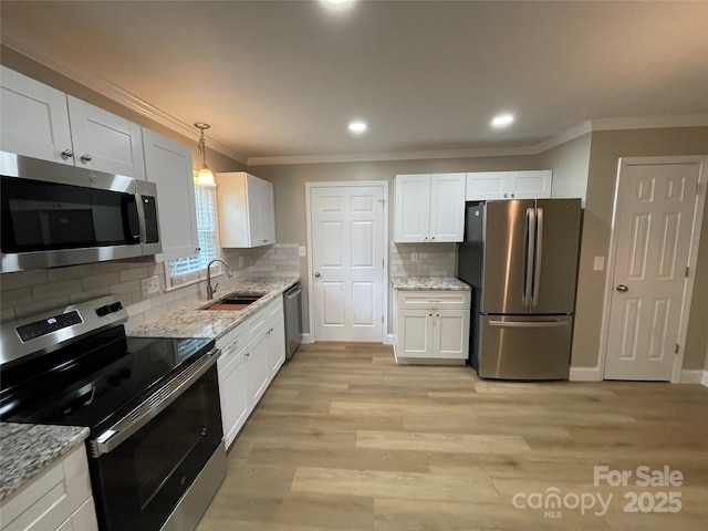 kitchen featuring light stone countertops, appliances with stainless steel finishes, sink, and white cabinets