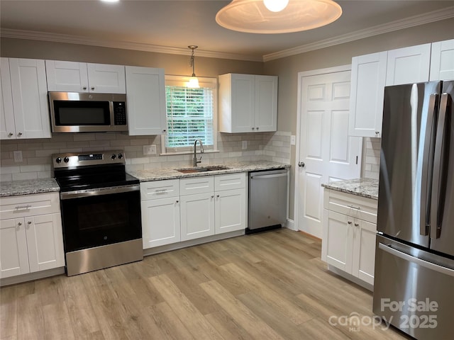 kitchen with white cabinetry, appliances with stainless steel finishes, sink, and hanging light fixtures