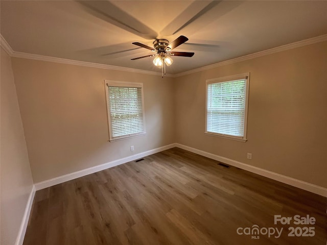 unfurnished room with ornamental molding, wood-type flooring, and a wealth of natural light