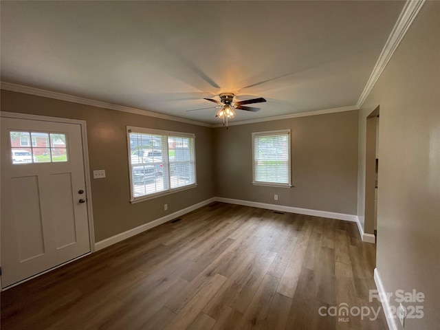 foyer entrance featuring hardwood / wood-style flooring, ornamental molding, and ceiling fan