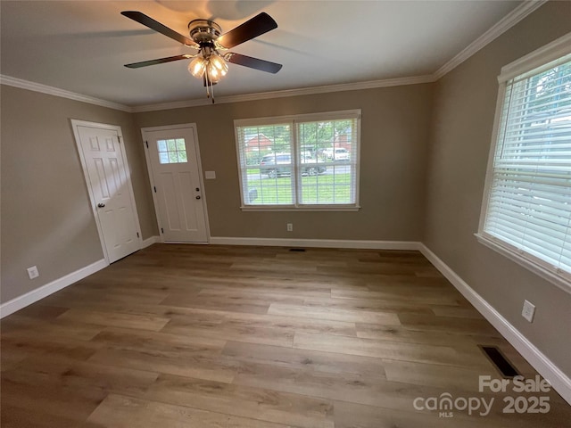 entryway with ceiling fan, ornamental molding, and light hardwood / wood-style flooring