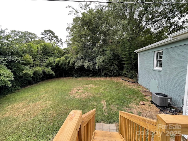 view of yard featuring central air condition unit