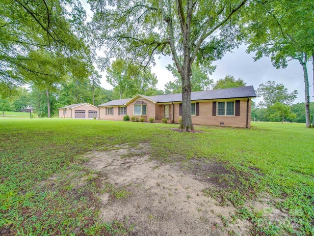 single story home featuring a front yard and a garage