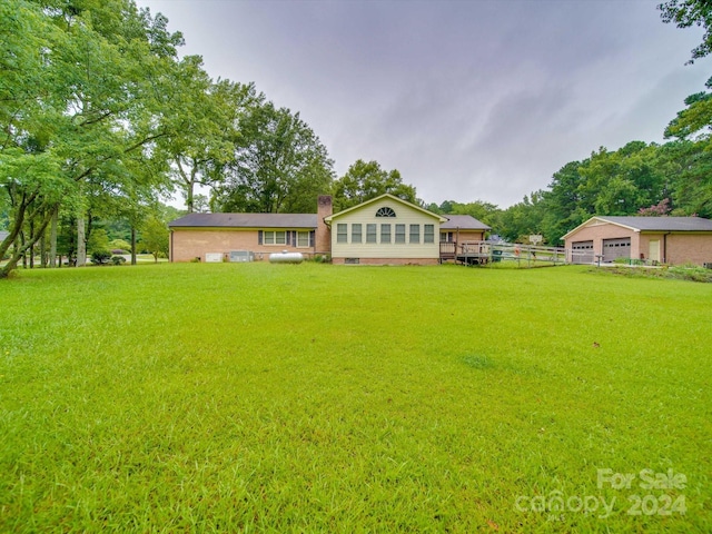 back of house with a lawn