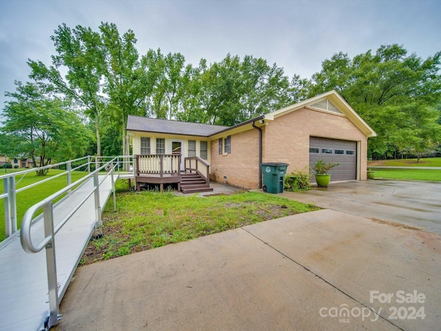 view of front of house featuring a wooden deck and a garage