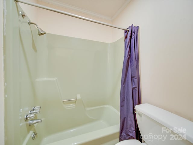 bathroom with crown molding, shower / bath combination with curtain, and toilet