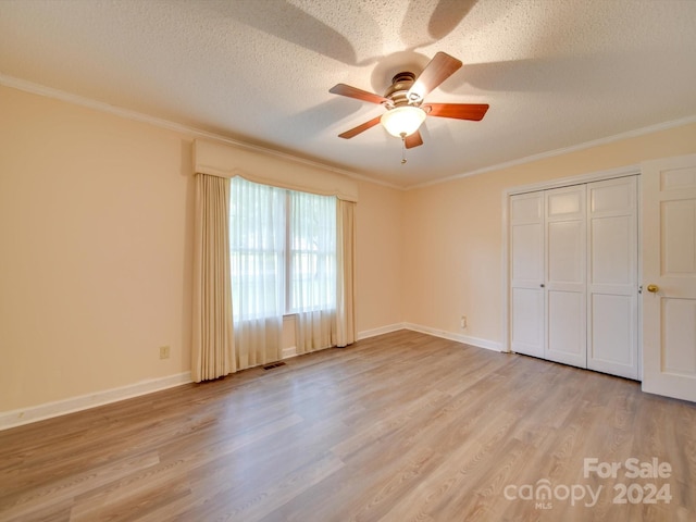 unfurnished bedroom with crown molding, ceiling fan, light hardwood / wood-style flooring, and a textured ceiling