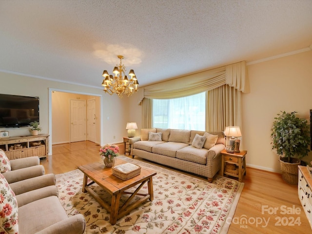 living room with crown molding, a chandelier, a textured ceiling, and light wood-type flooring