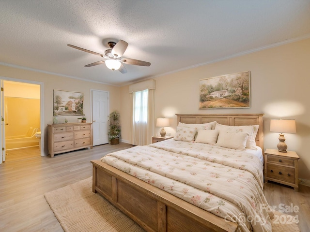 bedroom with connected bathroom, light hardwood / wood-style flooring, crown molding, a textured ceiling, and ceiling fan