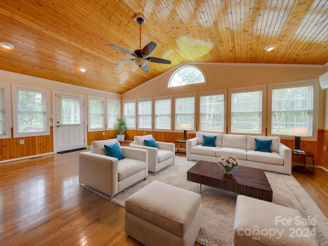 living room featuring wood ceiling, vaulted ceiling, light hardwood / wood-style floors, and wood walls