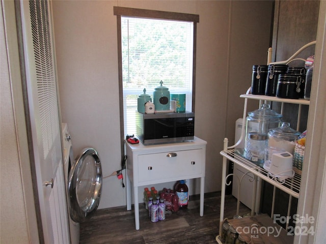 clothes washing area featuring dark wood-type flooring