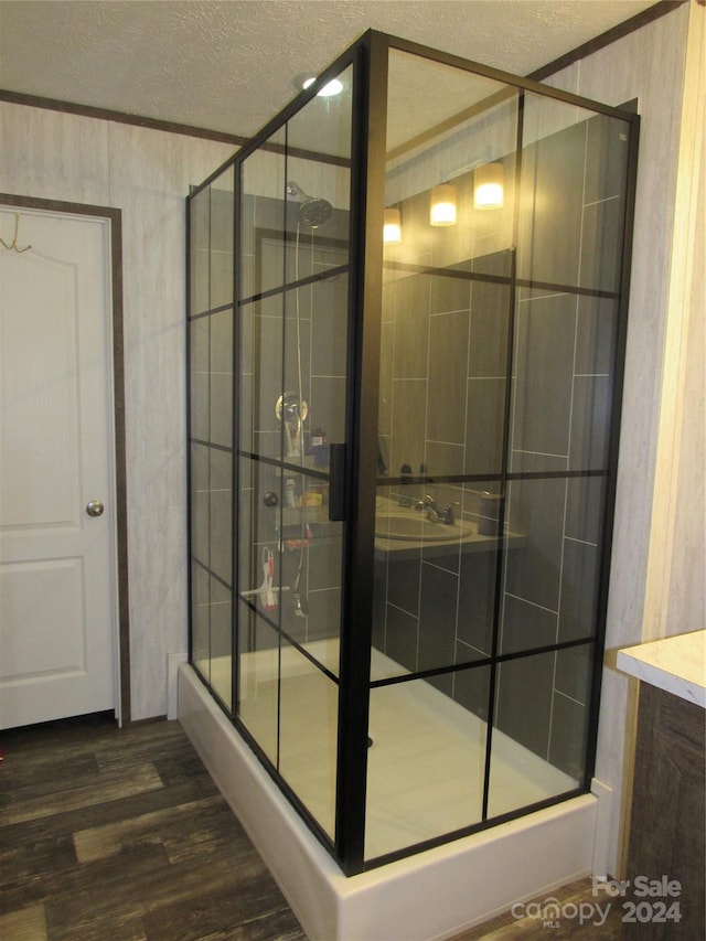 bathroom with vanity, a textured ceiling, and hardwood / wood-style flooring