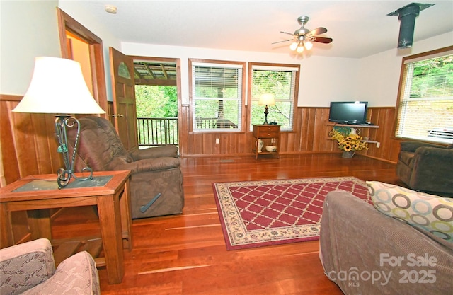 living room featuring ceiling fan and hardwood / wood-style floors