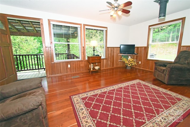 living room with hardwood / wood-style flooring and ceiling fan