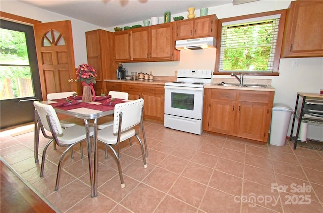 kitchen featuring light tile patterned flooring, sink, and electric stove