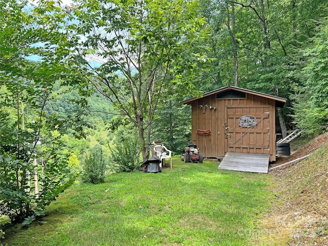 view of outbuilding featuring a yard