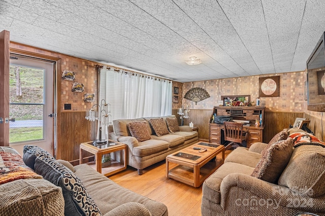 living room featuring wood walls and hardwood / wood-style floors