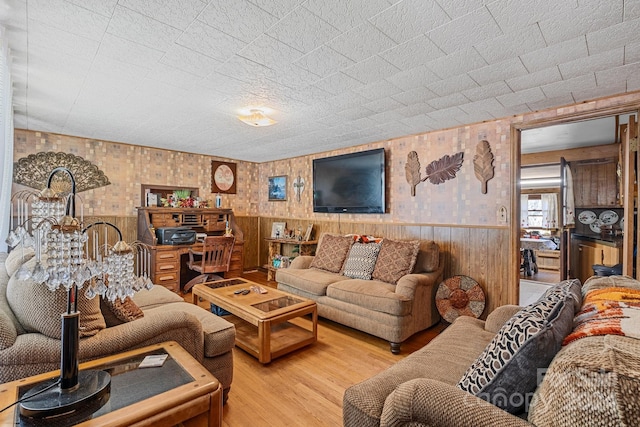 living room with wood walls and hardwood / wood-style flooring