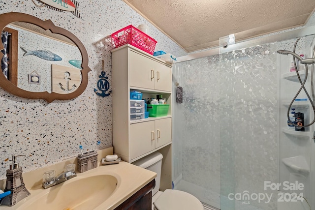 bathroom featuring vanity, an enclosed shower, a textured ceiling, and toilet