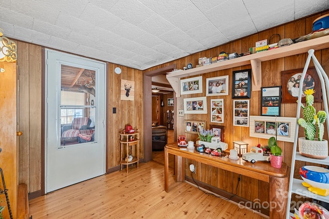 office area featuring light hardwood / wood-style flooring and wooden walls