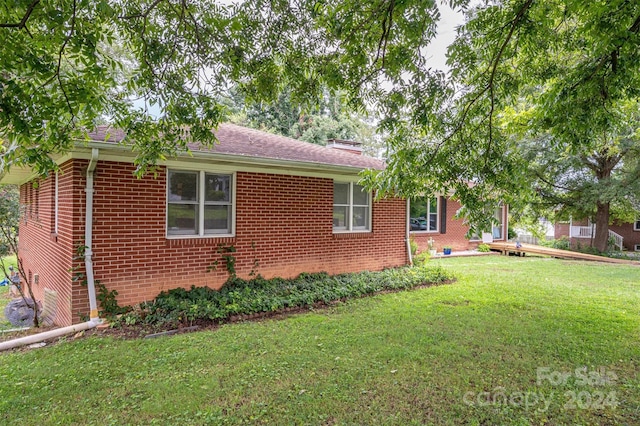 view of home's exterior with a yard