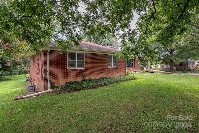 view of home's exterior with a lawn