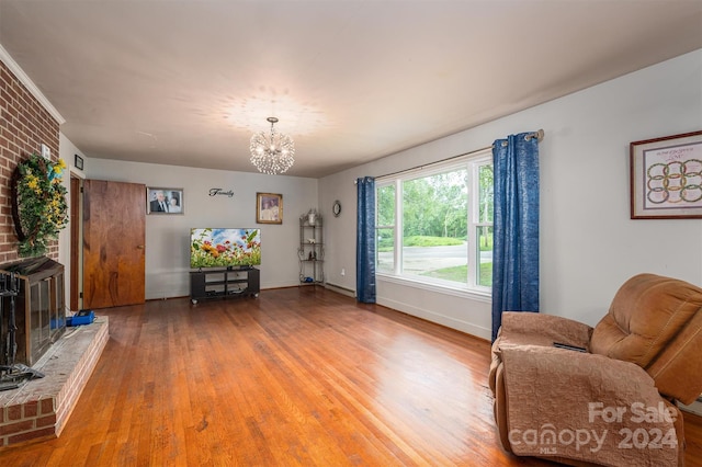 sitting room featuring wood-type flooring and a notable chandelier