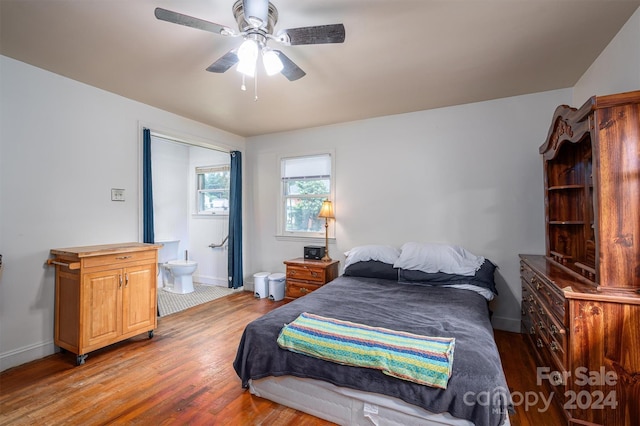 bedroom with connected bathroom, hardwood / wood-style flooring, and ceiling fan