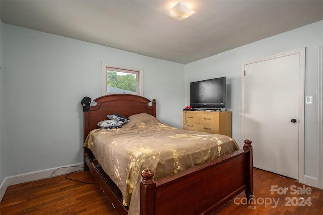 bedroom with dark wood-type flooring